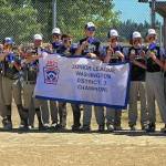 PHOTO COURTESY OF WASHINGTON DISTRICT 3 LITTLE LEAGUE 
The Willapa Harbor Junior League all-stars celebrate with a championship banner after defeating Capitol 16-0 on Saturday in Olympia.