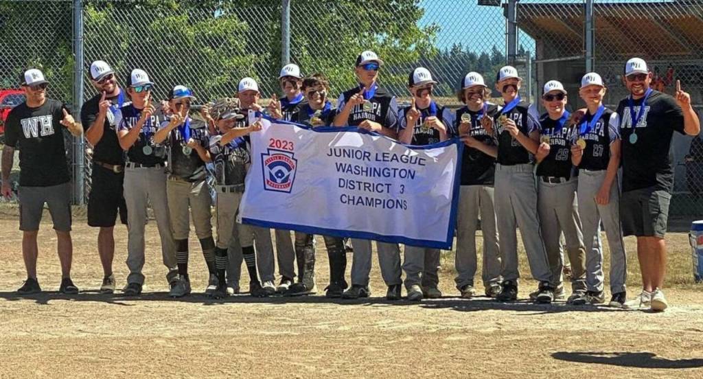 PHOTO COURTESY OF WASHINGTON DISTRICT 3 LITTLE LEAGUE 
The Willapa Harbor Junior League all-stars celebrate with a championship banner after defeating Capitol 16-0 on Saturday in Olympia.