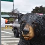 Food and craft vendors ready their tents behind a bear statue near city hall in McCleary for the 64 annual McCleary Bear Festival. (Clayton Franke / The Daily World)
