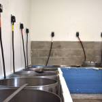 Sue Michalak-Budsberg, right, has led the McCleary Bear Festival stew preparations for 25 years. As part of this years stew, hundreds of pounds of vegetables chopped by volunteers Friday morning  along with ground beef and spices  will enter these large cooking pots in the Beerbower Park kitchen. The stew will be served 1 p.m. Saturday. (Clayton Franke / The Daily World)