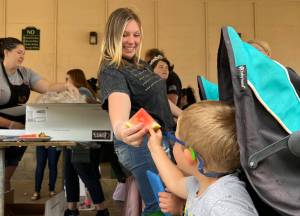 Clayton Franke / The Daily World
Sami McElravy hands a slice of watermelon to a young festival-goer on Saturday, July 8 at the McCleary Bear Festival.