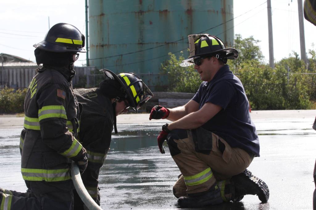 Michael S. Lockett / The Daily World
Derek Jensen of the Hoquiam Fire Department, right, teaches a group of high schoolers taking part in a fire science program about using a firehose.