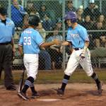 RYAN SPARKS | THE DAILY WORLD Bellevue Nationals Ryota Suzuki (1) is congratulated by Leland Chen after hitting a leadoff home run in the fifth inning of a 14-0 win over Elma at the Little League Intermediate State Tournament on Thursday in Elma.