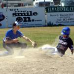 RYAN SPARKS | THE DAILY WORLD Elma short stop Jace Gustafson tags out Bellevue Nationals Alex Lee during the Little League State Intermediate Championship on Saturday in Elma.