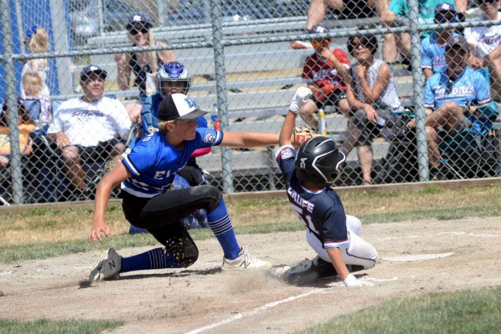 RYAN SPARKS | THE DAILY WORLD Elma pitcher Brysten Crawford, left records an out against Bellevue Nationals Ben Haufe during a 6-3 victory on Saturday in Elma.