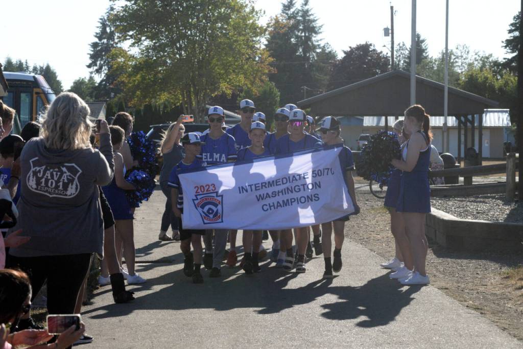 RYAN SPARKS | THE DAILY WORLD The Elma Intermediate 50/70 all-stars are greeted by fans upon entering Lloyd Murrey Park in a ceremony on Tuesday in Elma.