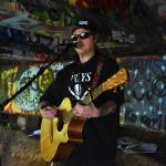 Matthew N. Wells / The Daily World
Clinton Dogger Mullins plays under the Young Street Bridge in early June. Mullins is pre-releasing his new album Atta Bomb on Saturday via the major streaming services. Hell also sell a CD version of the pre-release at his live shows. People who buy the pre-released CD will be able to exchange it for the album with the finished details.