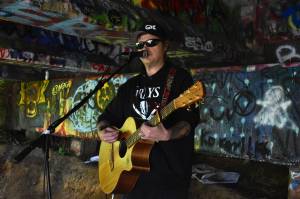 Matthew N. Wells / The Daily World
Clinton Dogger Mullins plays under the Young Street Bridge in early June. Mullins is pre-releasing his new album Atta Bomb on Saturday via the major streaming services. Hell also sell a CD version of the pre-release at his live shows. People who buy the pre-released CD will be able to exchange it for the album with the finished details.