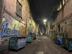 Matthew N. Wells / The Daily World
The darkened alleys throughout downtown Aberdeen have been lit up in an effort to help with safety and security for people and for property. The lighting of the alleys was mentioned in part of the work the city has done to make the city safer. While the dumpsters pictured are for nearby businesses and most are locked throughout the day and night, there is still an abundance of garbage people have to pick up. The survey results showed trash is a serious concern residents have.
