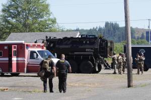 Members of the countys Crisis Response Unit pack up after supporting a Drug Task Force operation in Aberdeen on Wednesday morning. (Michael S. Lockett / The Daily World)