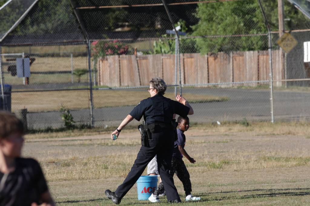 Michael S. Lockett / The Daily World
Elma Police Chief Susan Shultz prepares to get a child with a water balloon during the towns National Night Out event.