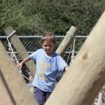 Cub Scout Jaxon Astry crosses a monkey bridge set up by the Scouts during the Grays Harbor County Fair. (Michael S. Lockett / The Daily World)