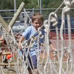 Michael S. Lockett / The Daily World
Cub Scout Jaxon Astry crosses a monkey bridge set up by the Scouts during the Grays Harbor County State Fair.