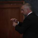 Jason Walker, leading the prosecution, simulates how the defendant may have held the revolver used in a shooting as he makes his closing statement on Aug. 18. (Michael S. Lockett / The Daily World)