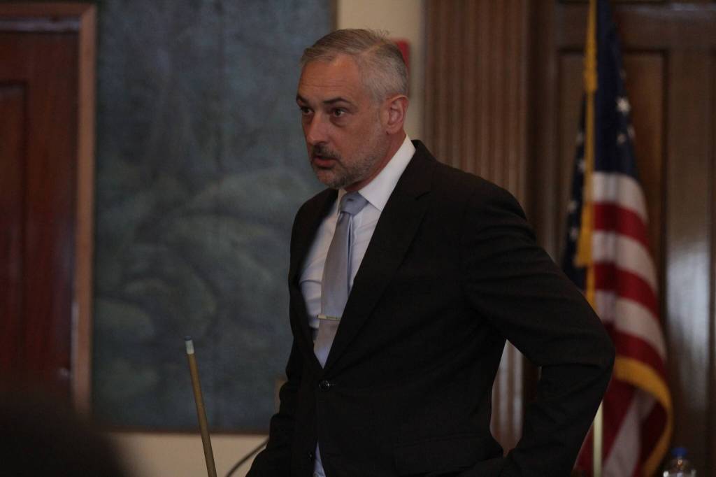 Jason Walker, leading the prosecution, holds a pool cue as he makes his closing statement on Aug. 18. (Michael S. Lockett / The Daily World)