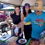 Dezy Lindgren, left, and her mom and dad, Michelle and Dan, worked through Saturday to bring melt in your mouth tri-tip, chicken and ribs for Summerfest. While they didnt win at the BBQ competition held later in the day, their team  Porky McBeef and the Cluckers  appeared to enjoy themselves Saturday as they were all smiles. I think its been a really fun event, Dezy said. Its great to see people down here enjoying themselves, the food and the atmosphere.