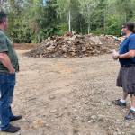 Michael S. Lockett / The Daily World
McCleary Public Works Director Chad Bedlington, left, and Mayor Chris Miller regard a pile of construction debris excavated from a dump site on Aug. 18.