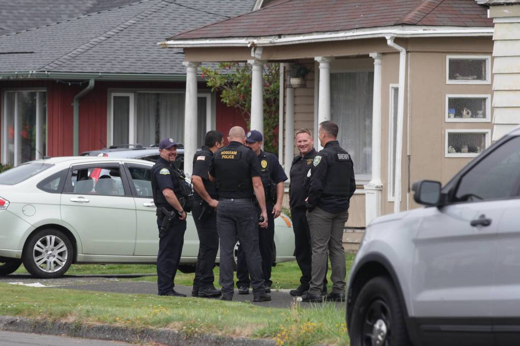 Michael S. Lockett / The Daily World
Police and fire personnel congregate after taking a man having a mental health crisis into protective custody in Hoquiam on Aug. 28.