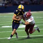 RYAN SPARKS | THE DAILY WORLD Aberdeen quarterback Grady Springer (4) tries to outrun Hoquiam linebacker Dominic Standstipher during the Bobcats 36-0 win on Friday at Stewart Field in Aberdeen.
