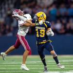 PHOTO BY FOREST WORGUM Aberdeen running back Aidan Watkins (19) stiff-arms Hoquiam defensive back Javonni Koth during the Bobcats 36-0 win on Friday at Stewart Field in Aberdeen. Watkins rushed for 110 yards and four touchdowns in the victory.
