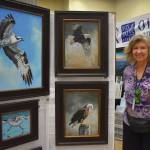 Matthew N. Wells / The Daily World
Karen Fox, who paints animals and vivid nature scenes, stands proudly by a few of her work this past weekend at the 54th annual Associated Arts Ocean Shores Arts & Crafts Festival. Fox has been painting since 1997, but much of her work accelerated during the COVID-19 pandemic. More of her work can be found by searching online for Fox Tales Studio.