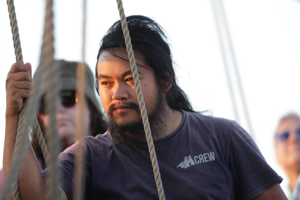 Kevin Ureta watches sailors as they adjust sails aboard the Lady Washington north of Olympia on September 2. (Michael S. Lockett / The Daily World)