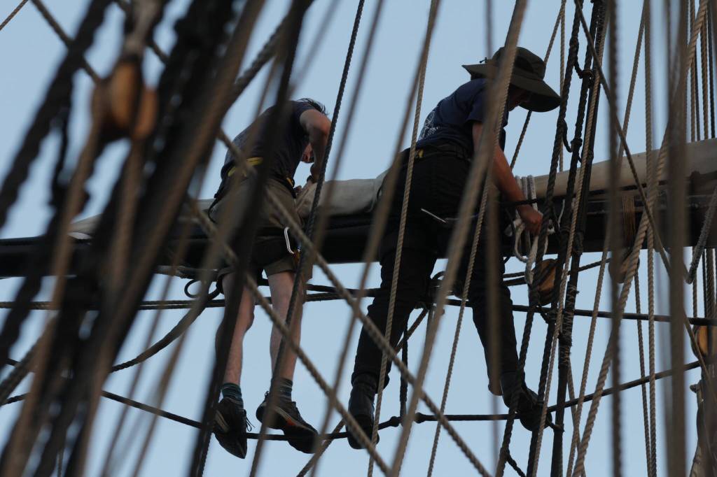 Sailors aloft adjust sails aboard the Lady Washington on September 2 in Olympia. (Michael S. Lockett / The Daily World)