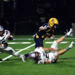 RYAN SPARKS | THE DAILY WORLD Aberdeen running back Aidan Watkins shakes the tackle of Montesanos Felix Romero (15) and Peyton Damasiewicz (52) during the Bobcats 38-7 loss on Friday at Stewart Field in Aberdeen.