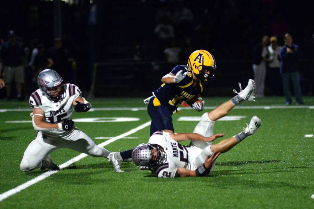 RYAN SPARKS | THE DAILY WORLD Aberdeen running back Aidan Watkins shakes the tackle of Montesanos Felix Romero (15) and Peyton Damasiewicz (52) during the Bobcats 38-7 loss on Friday at Stewart Field in Aberdeen.