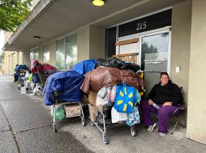 Clayton Franke / The Daily World
Noel Bollhoefer shelters under a concrete awning on East Market Street in Aberdeen across from the Aberdeen Police Department on Tuesday, Sept. 12.