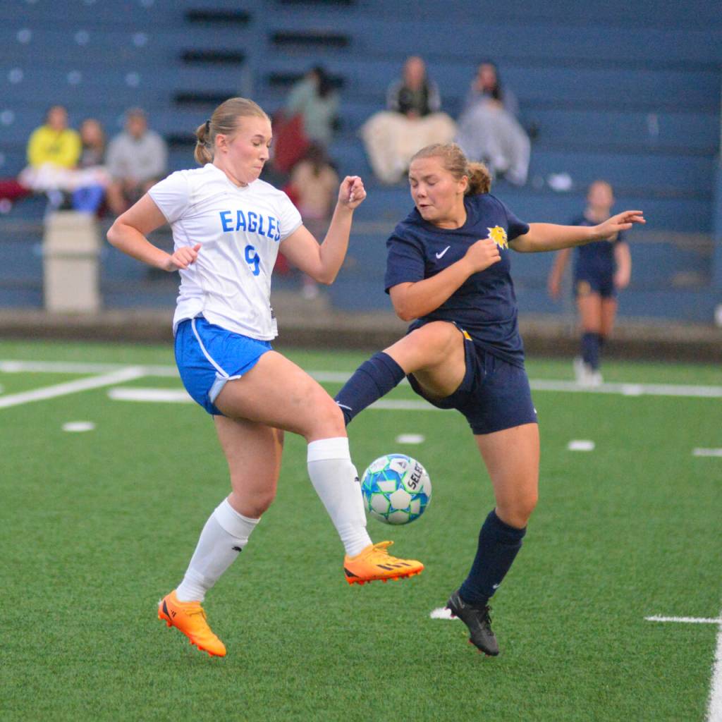 RYAN SPARKS | THE DAILY WORLD Elma midfielder Miley Seaberg (9) and Aberdeen midfielder Scotlyn Lecomte compete for possession during the Eagles 1-0 win on Tuesday at Stewart Field in Aberdeen.