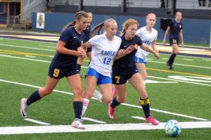 RYAN SPARKS | THE DAILY WORLD
Elma forward Beta Valentine (12) is squeezed by Aberdeen defenders Sawyer Shoemaker (9) and Zoe Troeh during the Eagles' 1-0 victory on Tuesday at Stewart Field in Aberdeen.