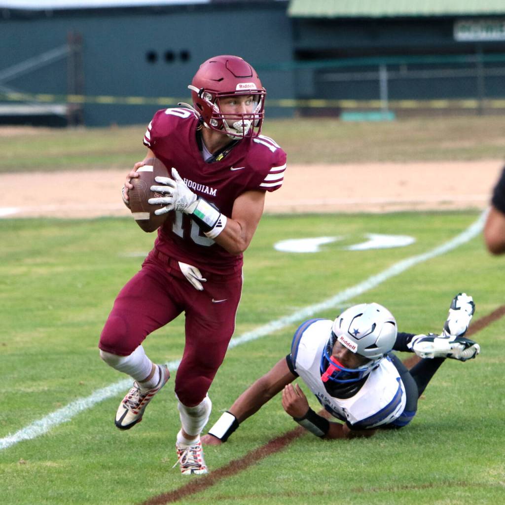 PHOTO BY BEN WINKELMAN Hoquiam quarterback Zander Jump rolls out during a 55-27 loss to La Salle on Friday at Olympic Stadium in Hoquiam.