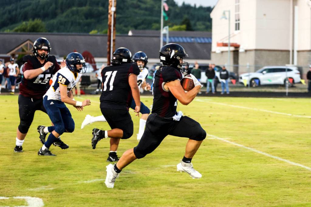 PHOTO BY LARRY BALE Raymond-South Bend running back Ferrill Johnson, right, breaks loose during a 41-14 victory over Ilwaco on Friday at Raymond High School.