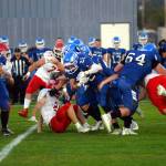 RYAN SPARKS | THE DAILY WORLD Elma running back Bo Muller (22) looks to squeeze through the Castle Rock defense during a 28-10 loss on Friday at Davis Field in Elma.