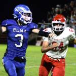 RYAN SPARKS | THE DAILY WORLD Elma backup quarterback Isaac McGaffey (3) looks to throw against Castle Rock defensive lineman Owen Keatley during the Eagles 28-10 loss on Friday at Davis Field in Elma.