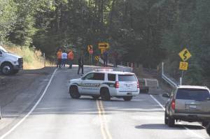 Members of the Grays Harbor Sheriffs Office block North River Road as crews clear up after a dump truck rolled over Monday morning. (Michael S. Lockett / The Daily World)