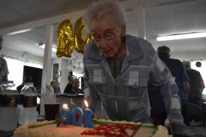 Clayton Franke / The Daily World
Faye Stringer blows out the candles on her 100th birthday cake at a party on Friday, Sept. 15 at Leisure Manor mobile home park in South Aberdeen. Stringer turns 100 on Sept. 26.
