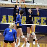 RYAN SPARKS | THE DAILY WORLD Aberdeens Lilly Camp (12) and Savannah Strickland (6) defend a shot by Rochesters Taylor Koehn during the Bobcats straight-set victory on Thursday at Sam Benn Gym in Aberdeen.
