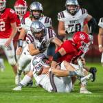 PHOTO BY FOREST WORGUM Montesano linebackers Peyton Damasiewicz (52) and Felix Romero (15) clamp down on Castle Rock running back Ian Burton during the Bulldogs 35-7 win on Thursday at Castle Rock High School.