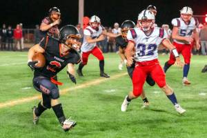 JARED WENZELBURGER | THE CHRONICLE Napavines Cael Stanley (2) evades Pe Ell-Willapa Valleys Blake Howard during a Friday evening game in Napavine.