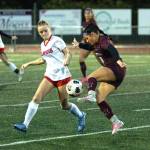 RYAN SPARKS | THE DAILY WORLD Montesanos Addi Potts, right, flicks the ball past Teninos Abby Robertson during the Bulldogs 4-0 win on Tuesday in Montesano.