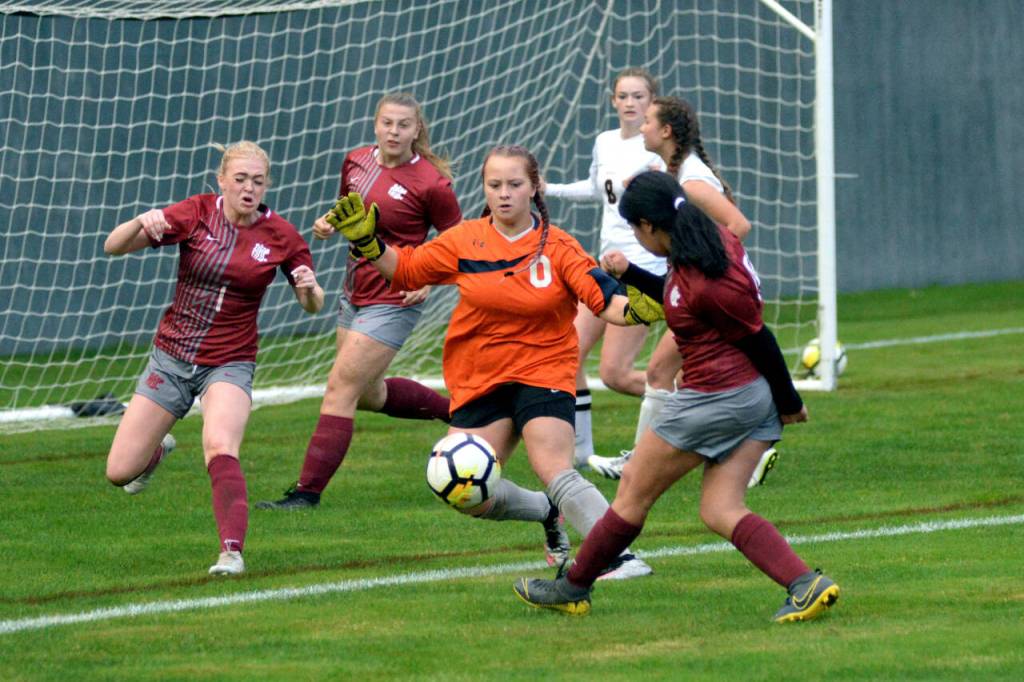 RYAN SPARKS | THE DAILY WORLD Ocosta goal keeper Amelia Saunders, middle, defends against Hoquiam shooter Vrizza Renteria-Hernandez, right, and Chloe Dietrick (1) during the Wildcats 1-0 win on Thursday at Olympic Stadium in Hoquiam.