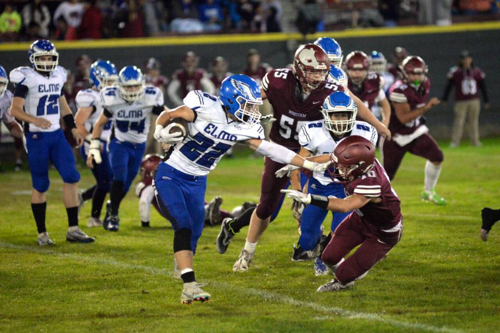RYAN SPARKS | THE DAILY WORLD Elma running back Bo Muller (22) runs against Hoquiam defender Zander Jump (10) during the Eagles 41-7 victory on Friday in Hoquiam.