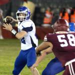 RYAN SPARKS | THE DAILY WORLD Elma quarterback Traden Carter, left, looks downfield during a 41-7 victory over Hoquiam on Friday at Olympic Stadium in Hoquiam.