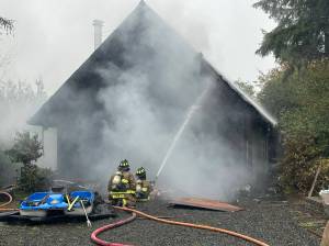 Courtesy photo / OSFD
Ocean Shores firefighters attack a house fire on Monday afternoon.