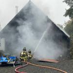 Ocean Shores firefighters attack a house fire on Monday afternoon. (Courtesy photo / OSFD)