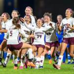 PHOTO BY FOREST WORGUM Montesanos Dekotah Parks (34) leads a contingent of Bulldogs as they embrace Sam Roundtree (5) after Roundtree scored the game-winning goal of a penalty-kick shootout against Elma on Tuesday in Elma.