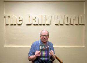 Matthew N. Wells / The Daily World
Rick Anderson, former sports editor for The Daily World, holds his first published book, Rewind: A Half-century of Classics, Cult Hits and other Must-see Movies. Anderson was effusive in his praise of former newspaper coworkers John Hughes, Doug Barker, Kat Bryant, Janet Simmelink and Jeff Burlingame for their assistance through his career and for helping him to get his book proofread and published.