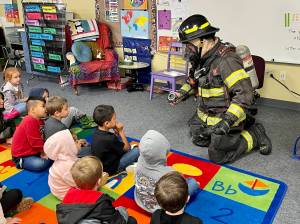 Michael S. Lockett / The Daily World
Aberdeen firefighter Kolby Lyle demonstrates his gear to kindergarten students at Robert Gray Elementary on Oct. 10 as part of Fire Prevention Week.